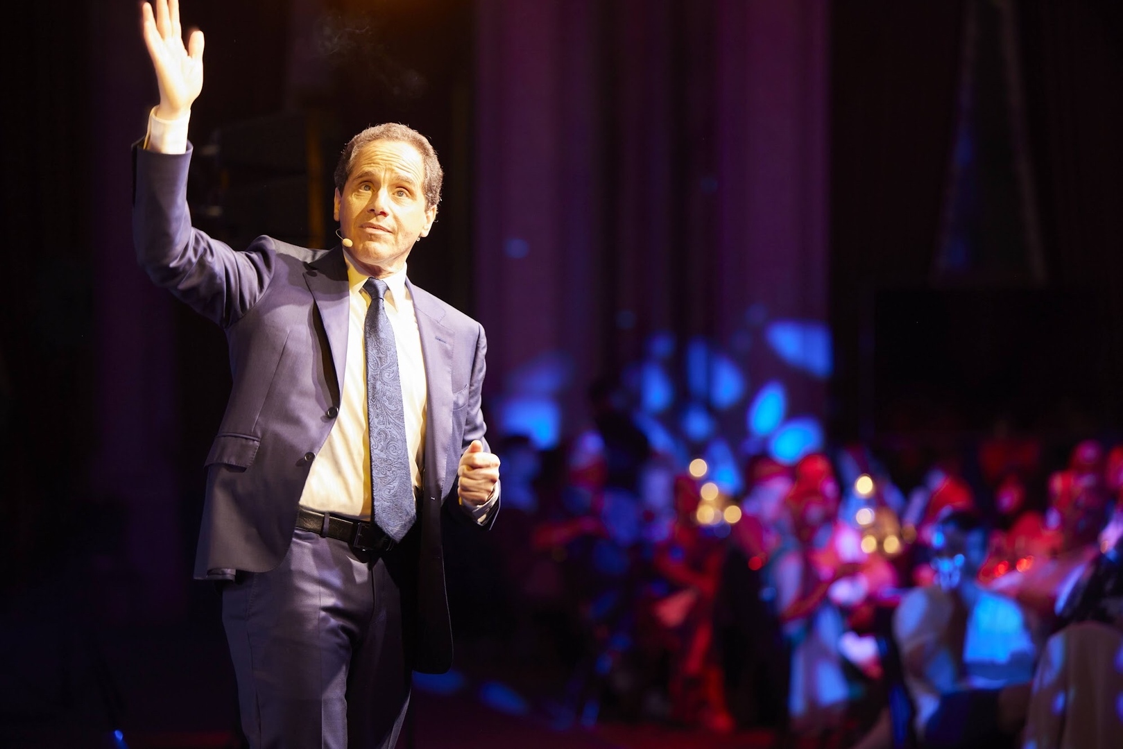 Man in suit addressing audience.