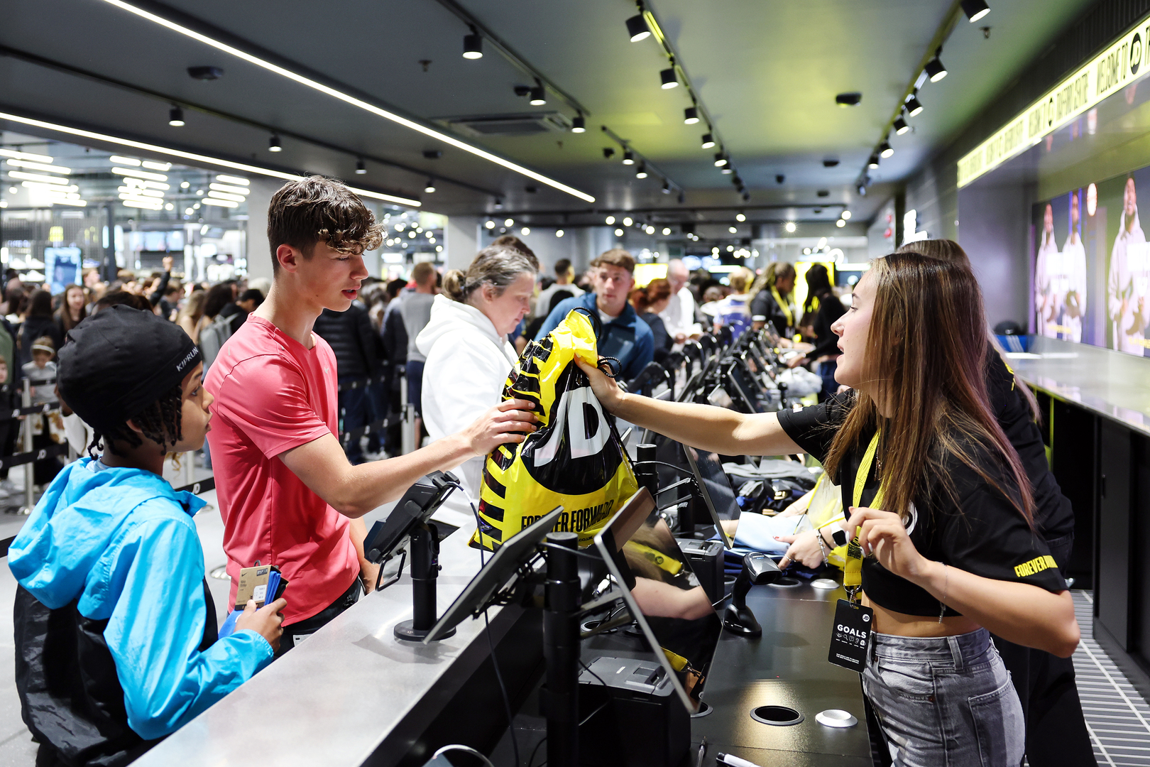 Customers checking out at a JD Sports store.